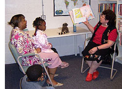 Volunteer reads to family